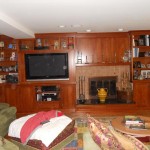 William H. Mann & Son Custom Built Cabinetry Entertainment Center with TV and devices